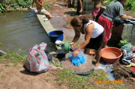 women of El Junco do their daily laundry at the water source area