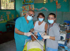 Dan, Leah, and Natasha Wernimont do some dental work